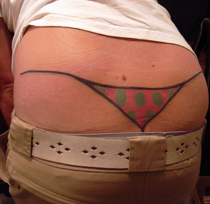 A poorly done tattoo of a thong on a person's lower back showing bad tattoos that prove thinking first is optional.