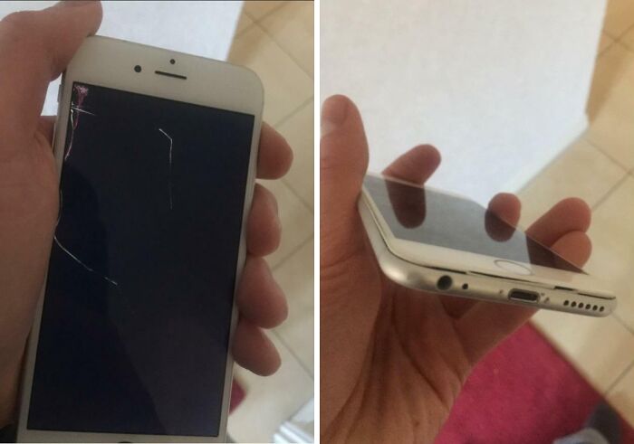 Hand holding a c*****d smartphone with a damaged charging port, illustrating boomers failed technology use moments.