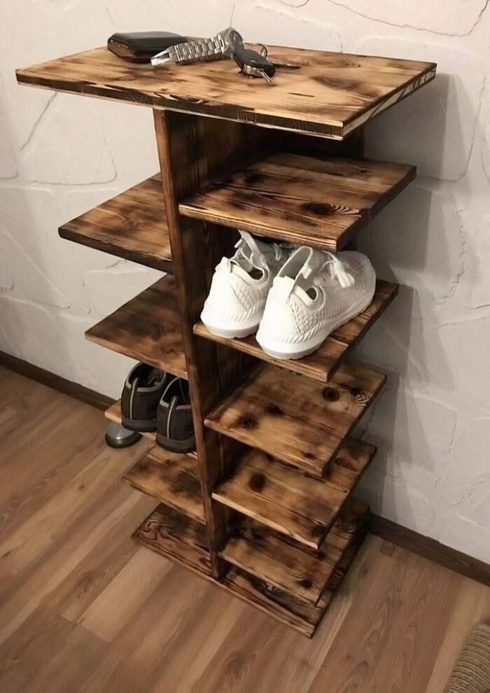 Wooden shoe rack with multiple shelves, showcasing talented woodworking and smooth carving craftsmanship in a home setting.