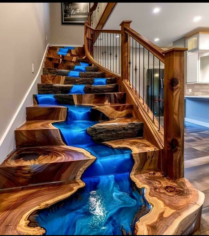 Wooden stairs with blue resin river design, showcasing unique and ridiculous home decor and DIY creativity with a bold artistic touch.