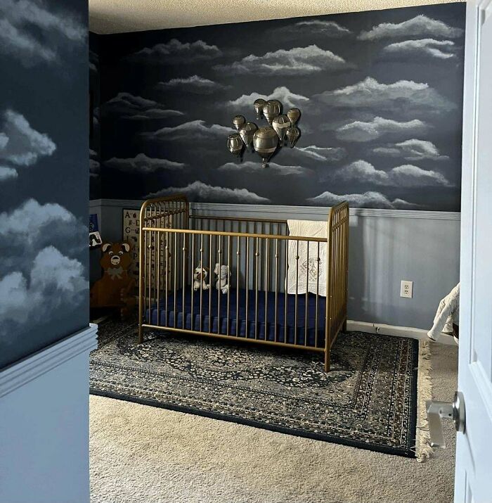 Nursery room with gold crib and dark cloud-themed walls showing ridiculous home decor and DIY ideas.