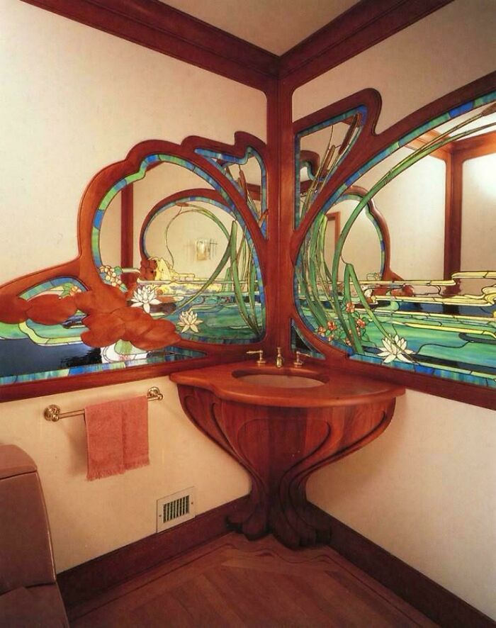 Unique corner bathroom sink with colorful stained glass mirror showcasing ridiculous home decor and DIY creativity.