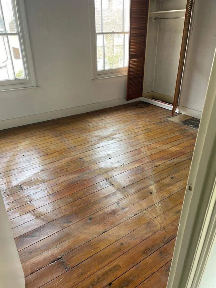 Empty room with wooden floors showing faded circular patterns, example of ridiculous home decor and DIY project fails.
