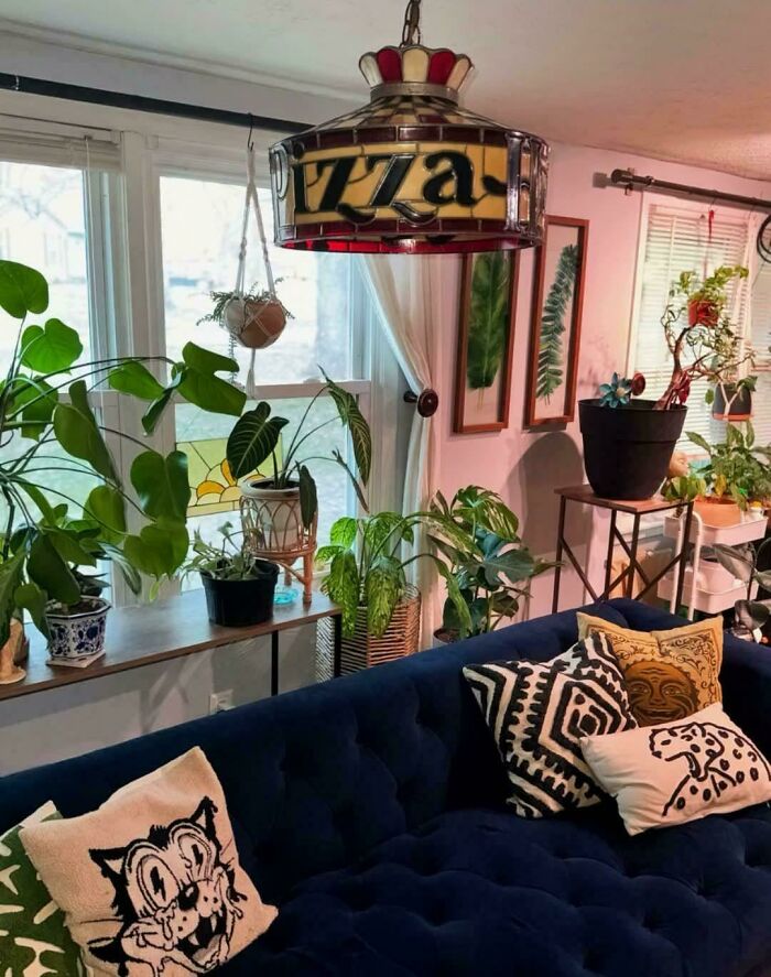Cozy living room with eclectic home decor, vibrant plants, and quirky handmade pillows showcasing ridiculous home decor style.
