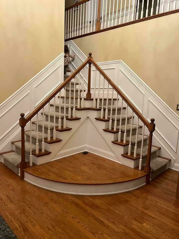 Unusual stair design with symmetrical railings and a raised wooden platform, showcasing ridiculous home decor and DIY fails.