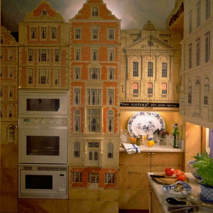 Kitchen appliances and cabinets designed with ridiculous home decor featuring building facades and funny DIY elements.