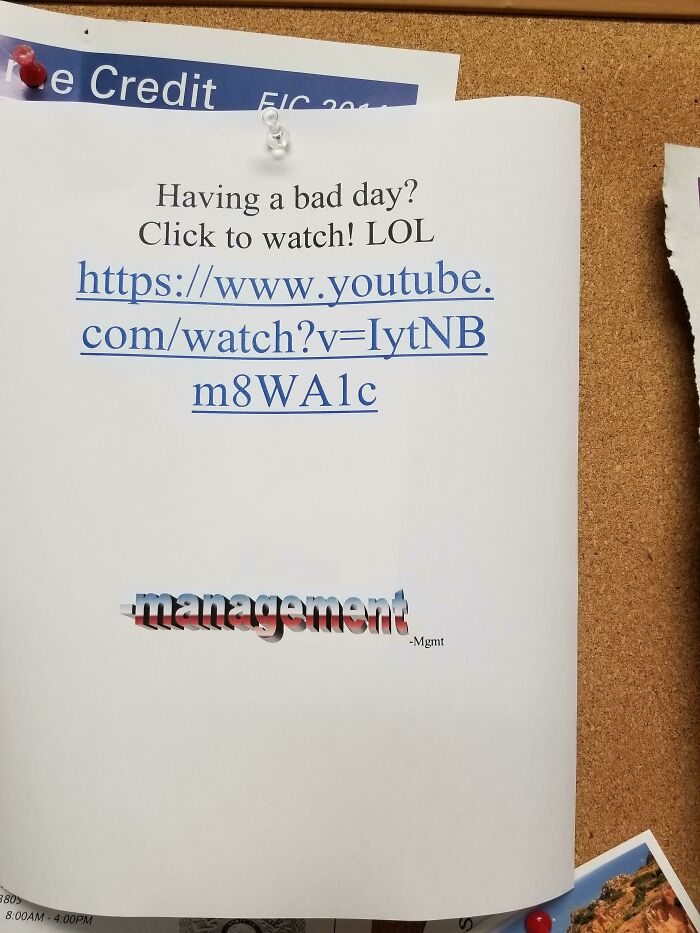 Office bulletin board with a pinned printed note linking to a YouTube video, humorously related to boomers using technology.