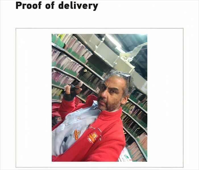 Delivery confirmation pic showing a driver in a red jacket taking a selfie as proof of delivery in a storage area.