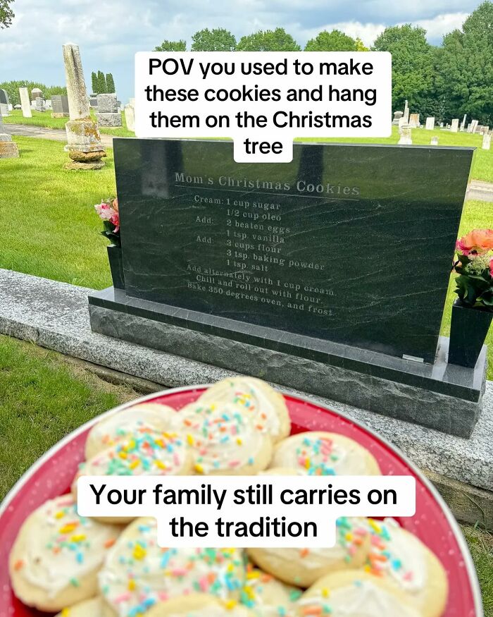 Tombstone etched with a Christmas cookie recipe in a cemetery, with a plate of frosted cookies in the foreground.