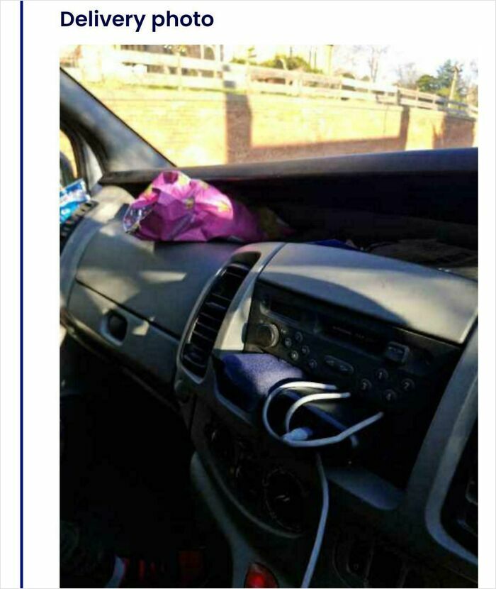 Delivery confirmation pic showing item left inside vehicle dashboard as part of hilarious delivery confirmation photos.