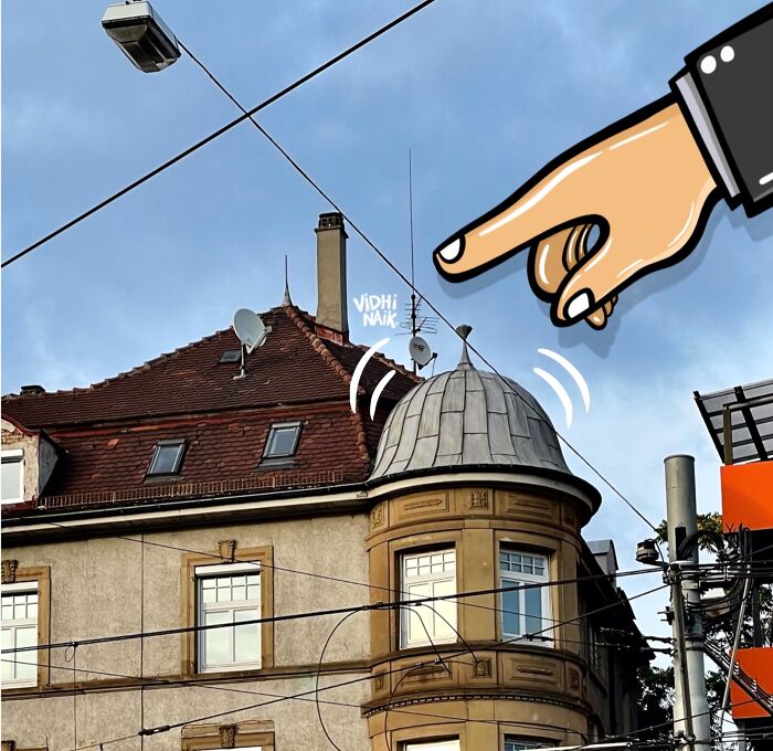 Cartoon scene of a large hand pointing at a rooftop antenna on a building in a creative everyday place artwork.