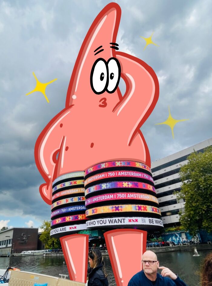 Cartoon scene of a giant pink star character integrated into an everyday urban riverside setting by the artist.
