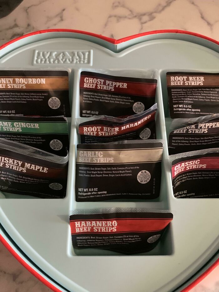 Heart-shaped box with assorted flavored beef strips as funny Valentine’s Day gifts for couples who enjoy spicy snacks.