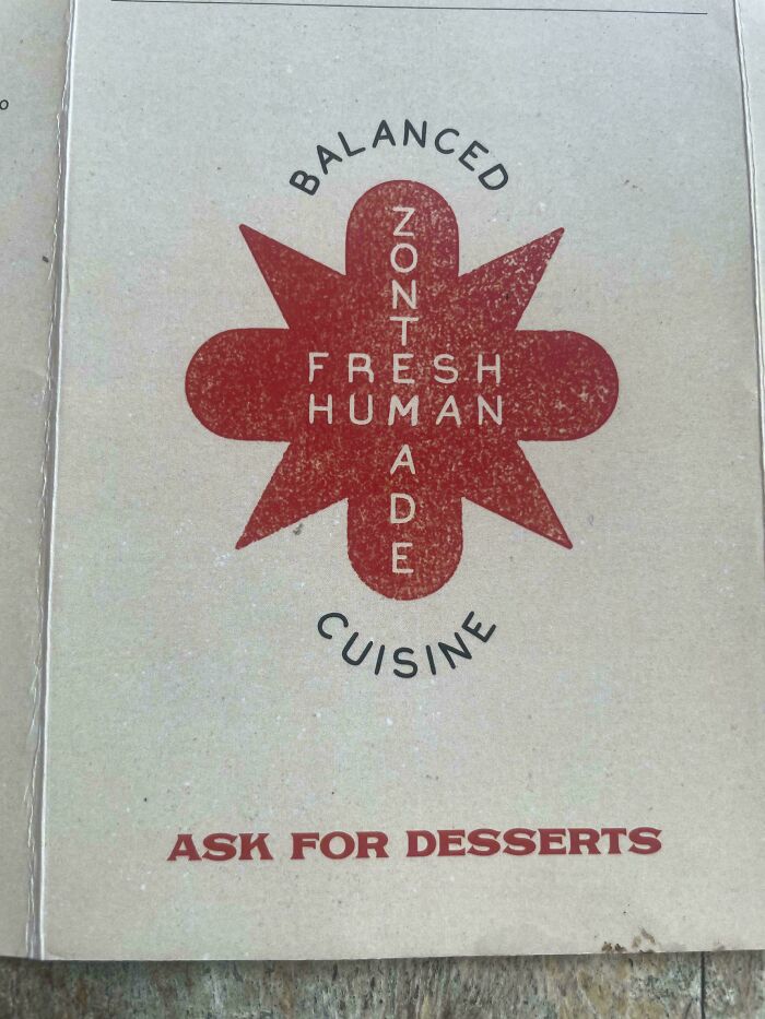 Menu with a red star design and the words BALANCED, NON-MADE FRESH HUMAN CUISINE, a bizarre design fail.
