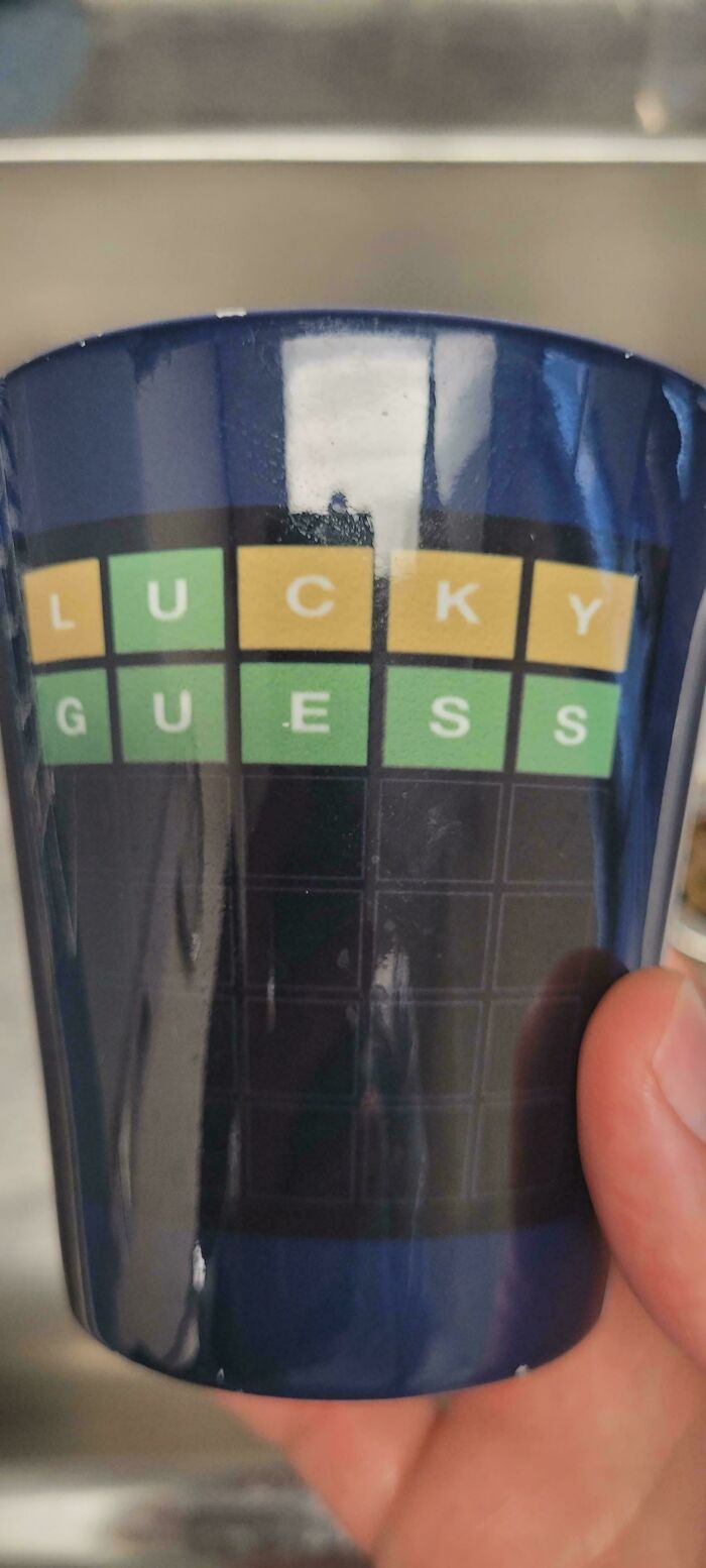 Blue shot glass with a Wordle-inspired design showing LUCKY GUESS, an unhinged design fail.
