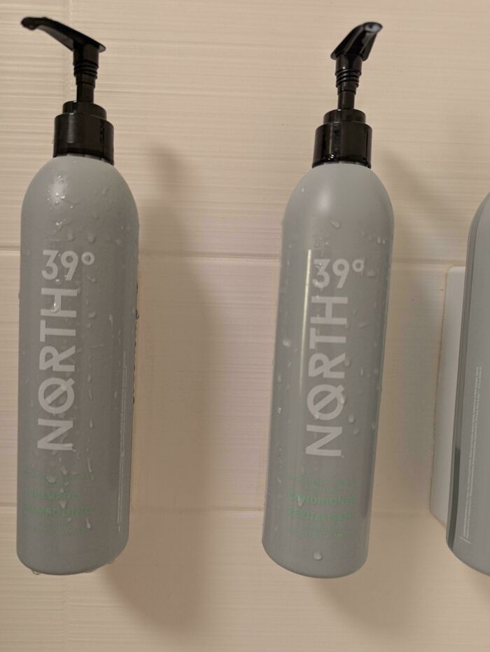 Hilariously unhinged design fail: shampoo and conditioner bottles labeled with North 39° and North 39°.