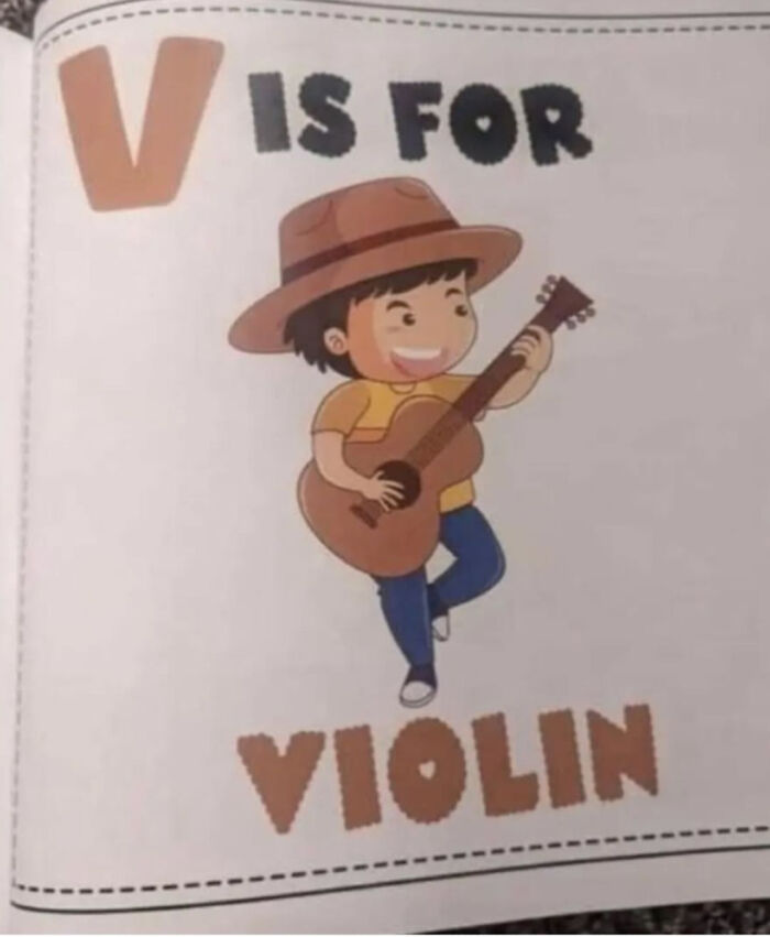 An alphabet book with V is for violin, next to an illustration of a boy playing a guitar, a design fail.