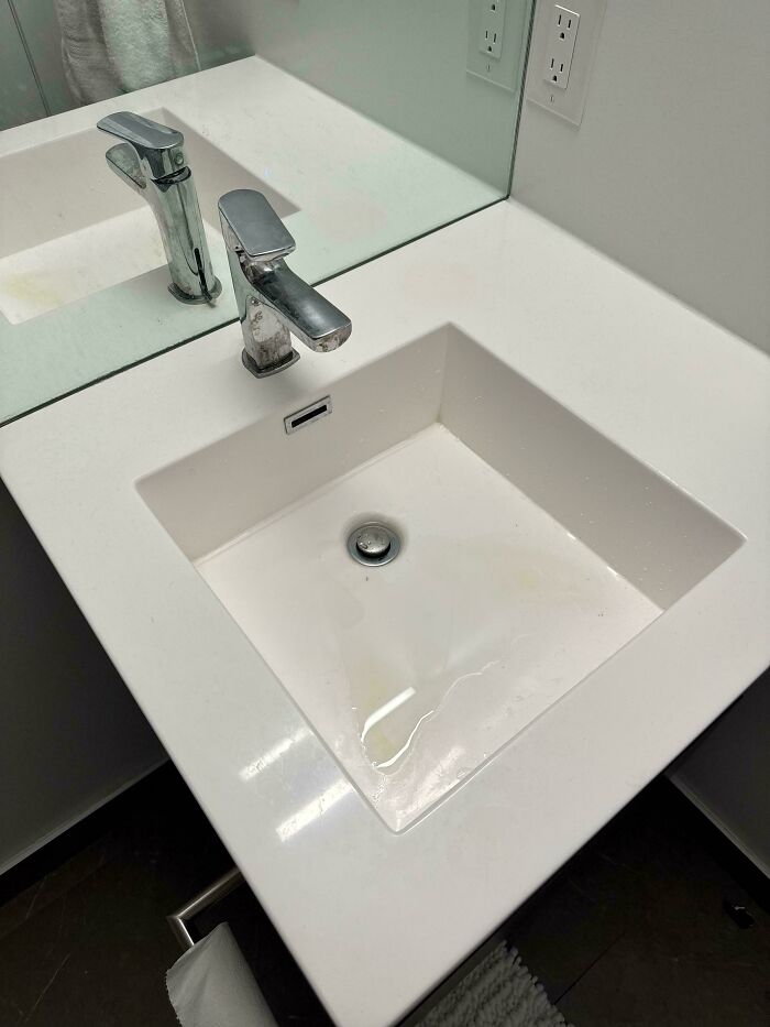 A poorly designed bathroom sink with the faucet too far back, exemplifying design fails.