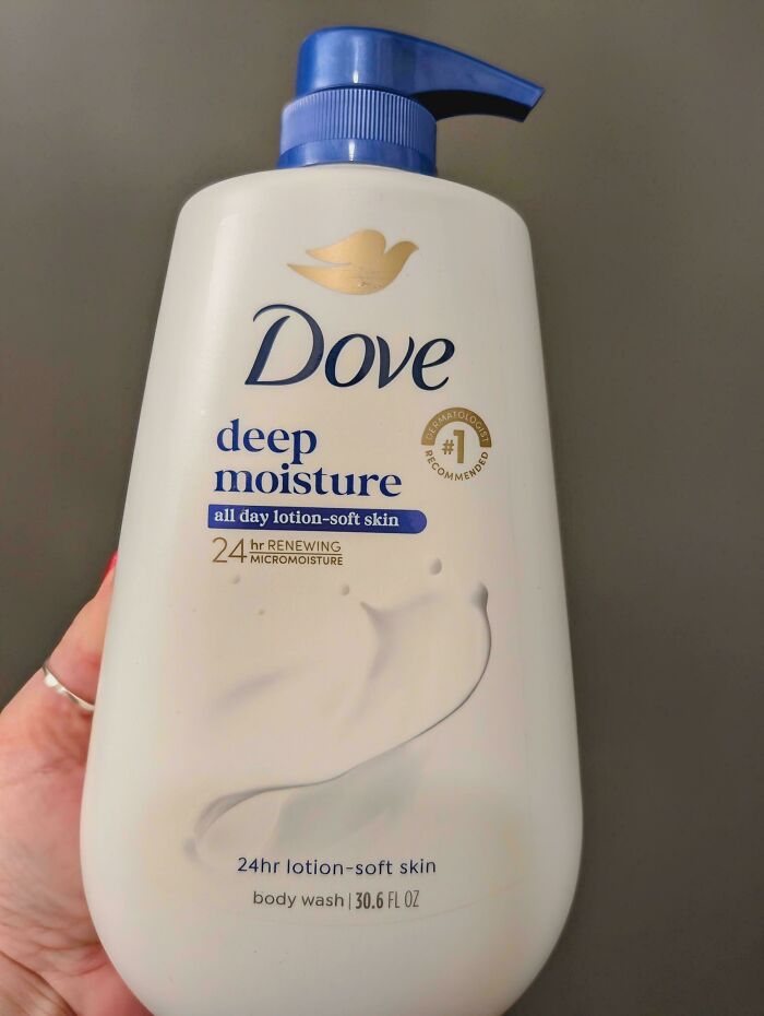 A hilariously unhinged design fail: a Dove body wash bottle with a pump facing the wrong way, making it inconvenient to use.