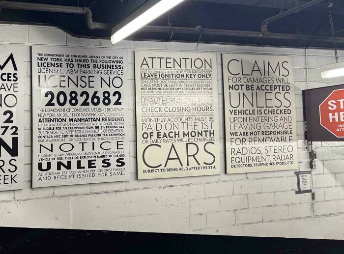 Three large, text-heavy signs on a brick wall, demonstrating a design fail in public information display.