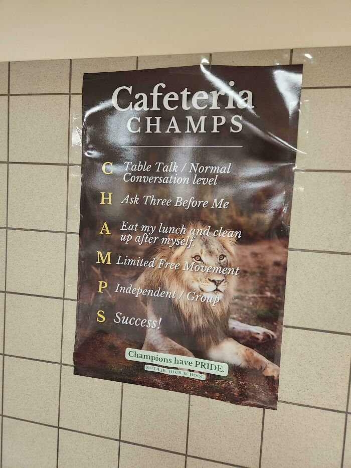 Cafeteria CHAMPS poster with a lion, highlighting a design fail in school communication.