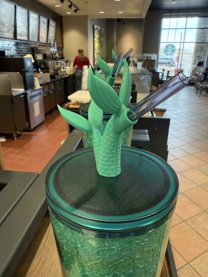 Green mermaid tail straw and cup display at a coffee shop, an example of design fails in retail.