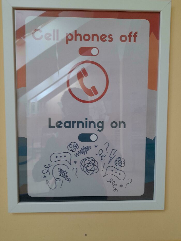 A framed sign showcasing a design fail: Cell phones off, Learning on with distracting doodles.