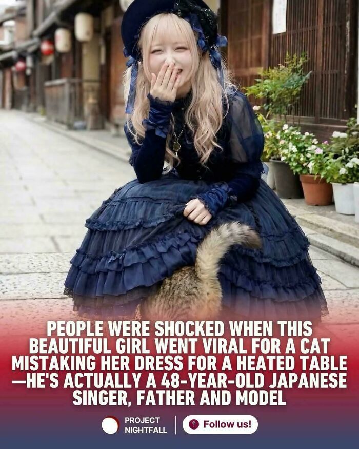 Young woman in a ruffled navy dress laughing while a cat hides under her skirt on a quiet street, highlighting viral unhinged sentences.