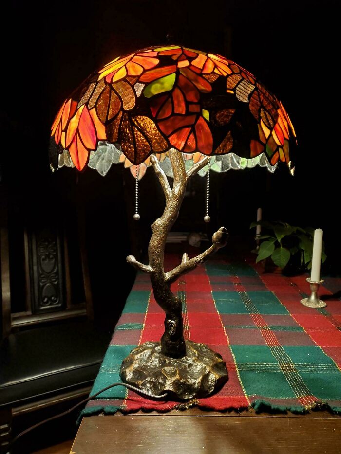 An artistic close-up of a tree-shaped lamp with a stained glass shade, an intricate home decor project.