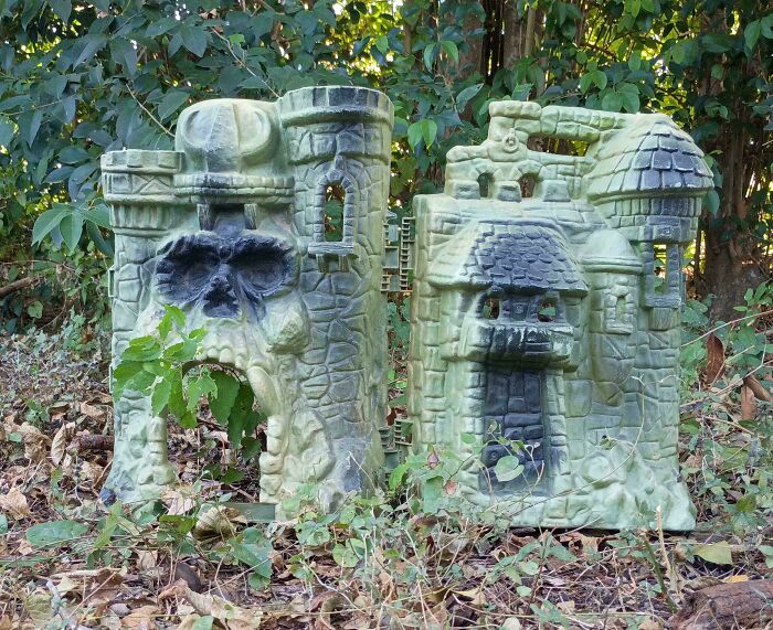 A large, ornate toy castle resembling a skull and other castle features, found during dumpster diving.