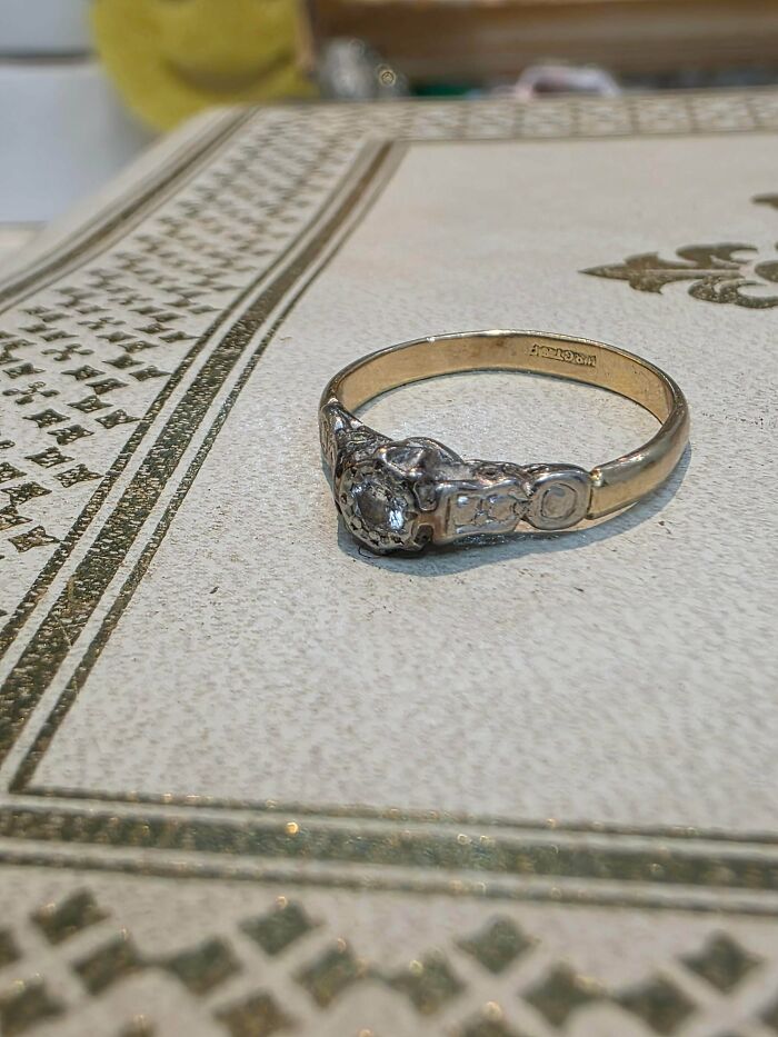 An antique-looking gold ring with several small diamonds, a precious item discovered while dumpster diving.