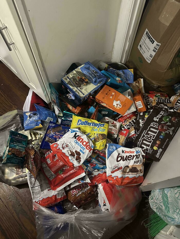 A large pile of various chocolate bars and candies, a lucky find from dumpster diving.