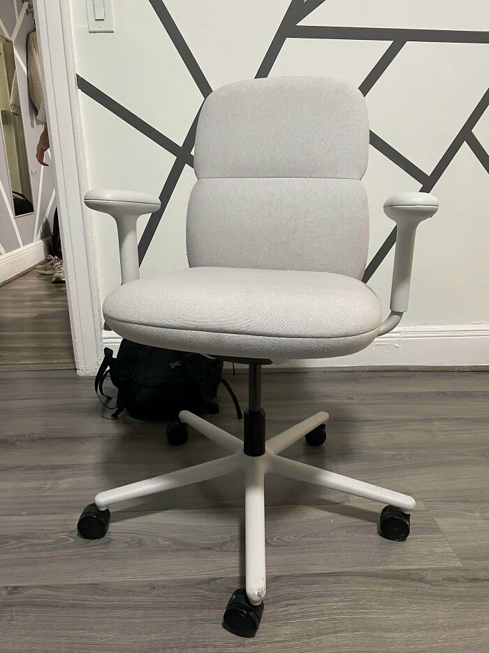 A clean, light grey office chair with white arms and base, found as a lucky dumpster diving find.