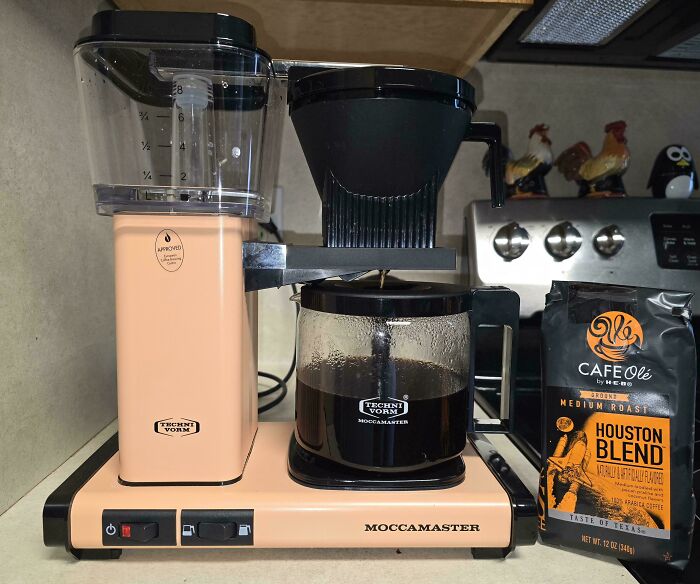 A Technivorm Moccamaster coffee maker and a bag of Cafe Ole Houston Blend coffee. A Buy It For Life purchase.