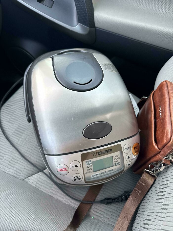 A silver Zojirushi rice cooker in a car, a Buy It For Life purchase that didn't disappoint.