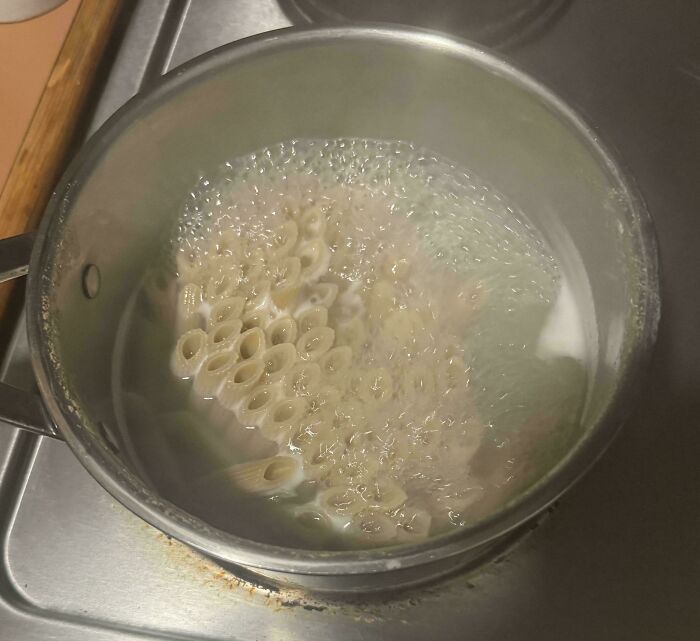Pasta boiling in a metal pot on a stovetop, capturing a moment from a collection of mildly interesting pictures.