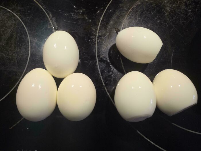 Mildly interesting picture of five hard-boiled eggs with perfectly smooth peels, ready to eat.