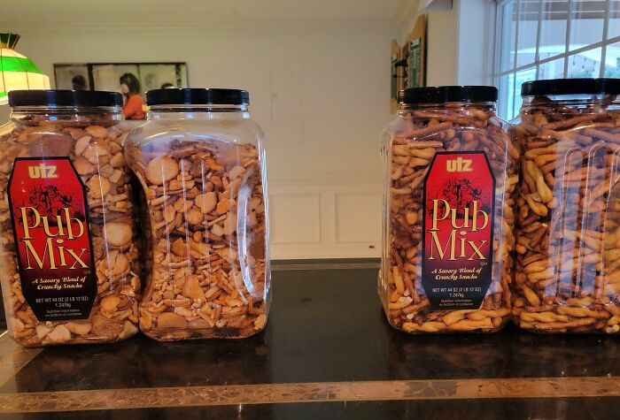 Large containers of Utz Pub Mix snack on a kitchen counter, a funny Valentine’s Day gift idea that brings laughter and snacks.