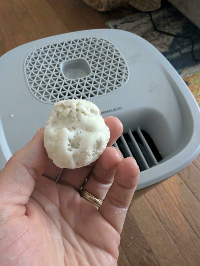 A hand holds a piece of white ice, one of many interesting pictures.