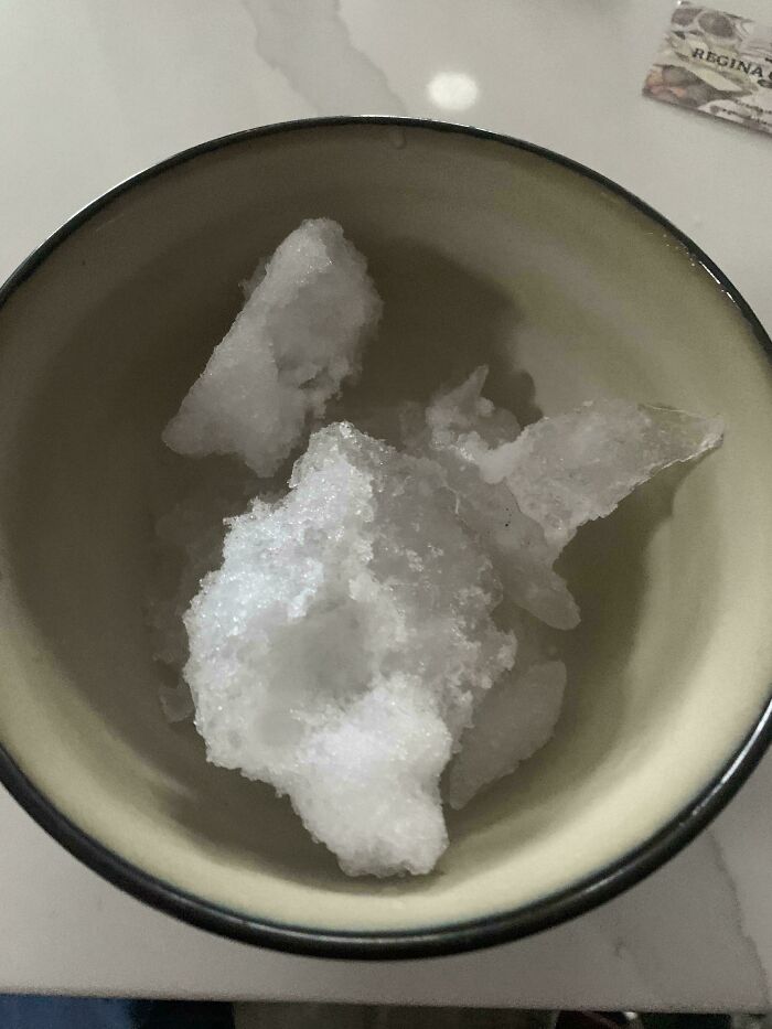Bowl containing irregular chunks of ice resembling a devil sunrise scene with textured white crystalline formations.