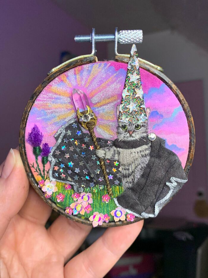 A stunning embroidery creation of a wizard cat with a staff and sparkling hat, inspiring embroidery hobbyists.