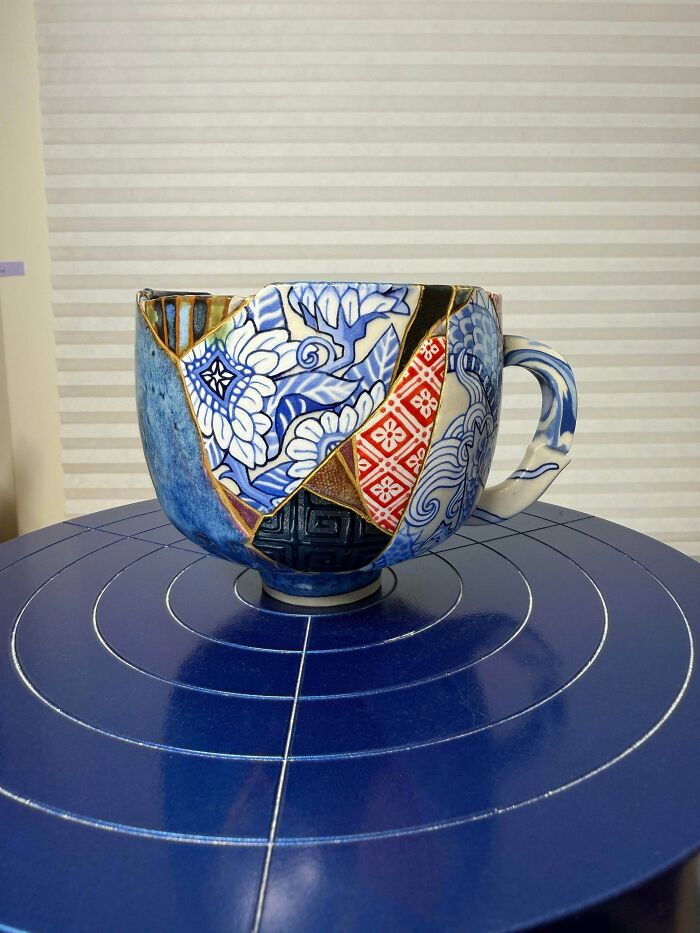 Patchwork ceramic cup with blue floral and geometric patterns, showcasing a DIY win and creative healing project.