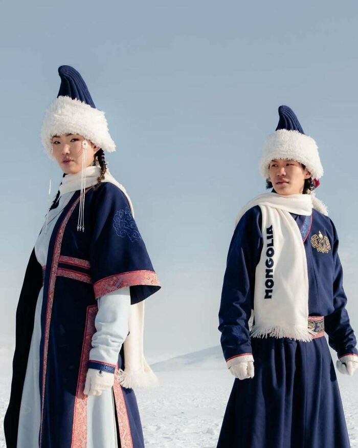 Amazing photo of two people in traditional Mongolian attire, teaching something new about culture.
