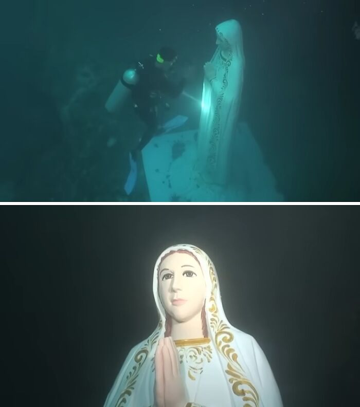 Underwater diver exploring a detailed religious statue in a deep ocean setting, showcasing unexpected ocean photos.