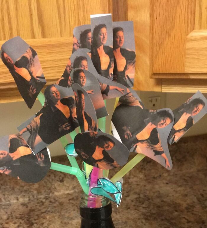 Funny Valentine’s Day gifts featuring a homemade bouquet of cut-out images from a romantic movie scene on colorful straws.