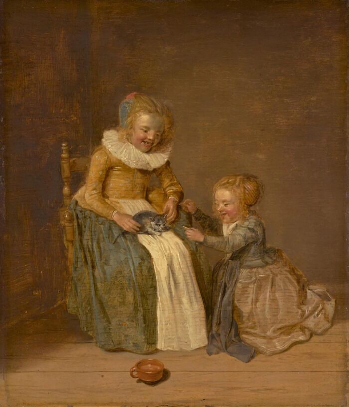 Two children in historic clothing playing with a cat in a classic cat-themed artwork painting.