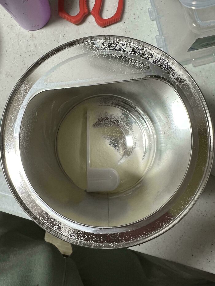 A photo of an almost empty can of baby formula, highlighting the humorous aspect of being a great dad.