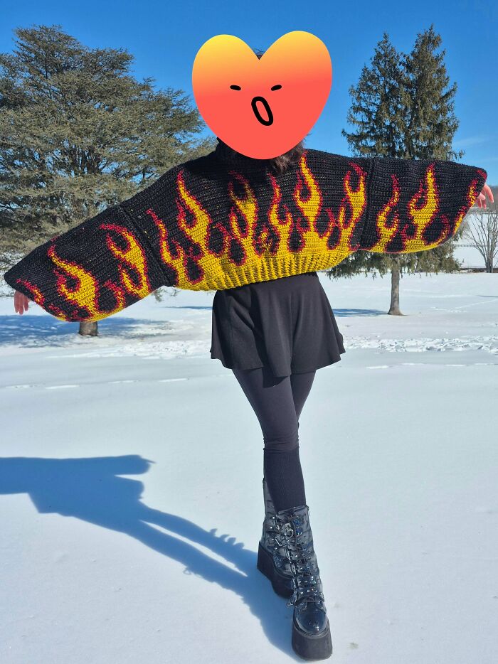 Awesome crocheted flame sweater, black mini skirt, and platform boots on a snowy day.