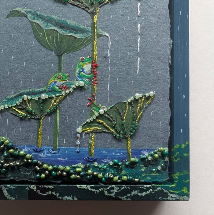 Intricate embroidery creation of frogs on lily pads in the rain, inspiring new hobby.