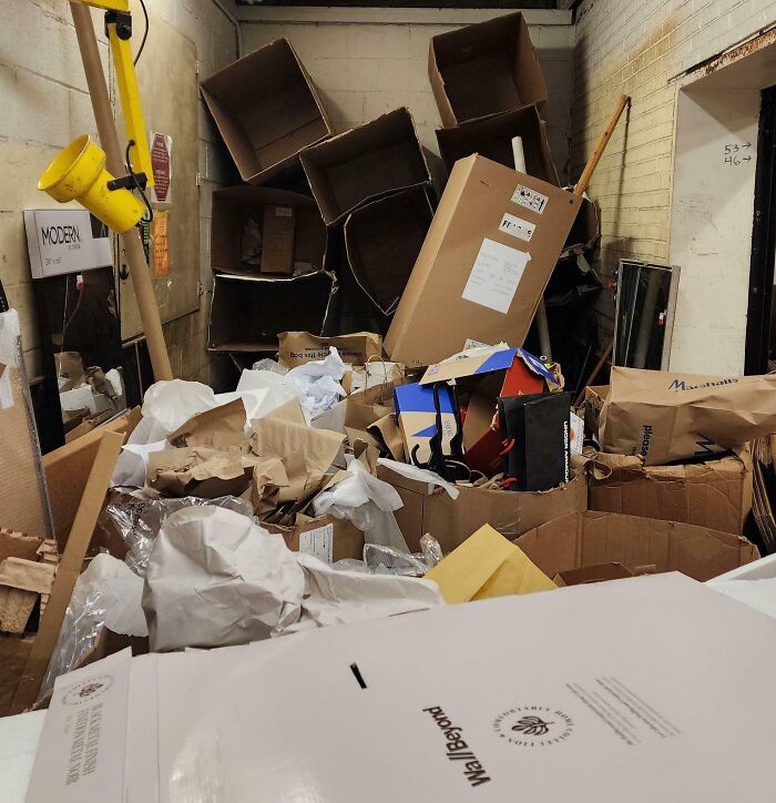 Cluttered room filled with scattered cardboard boxes and trash illustrating selfish and stupid behavior working with others.